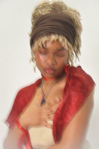 A woman with her right hand on her chest in a solemn pose