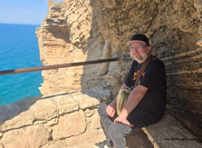Steve sitting by the coast